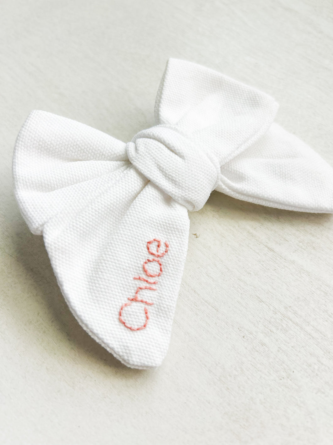Hand embroidered white bow