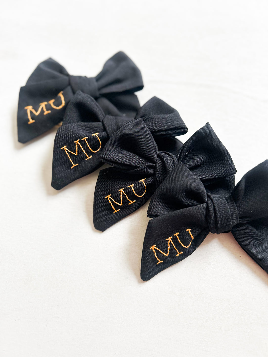 MU hand embroidered bow