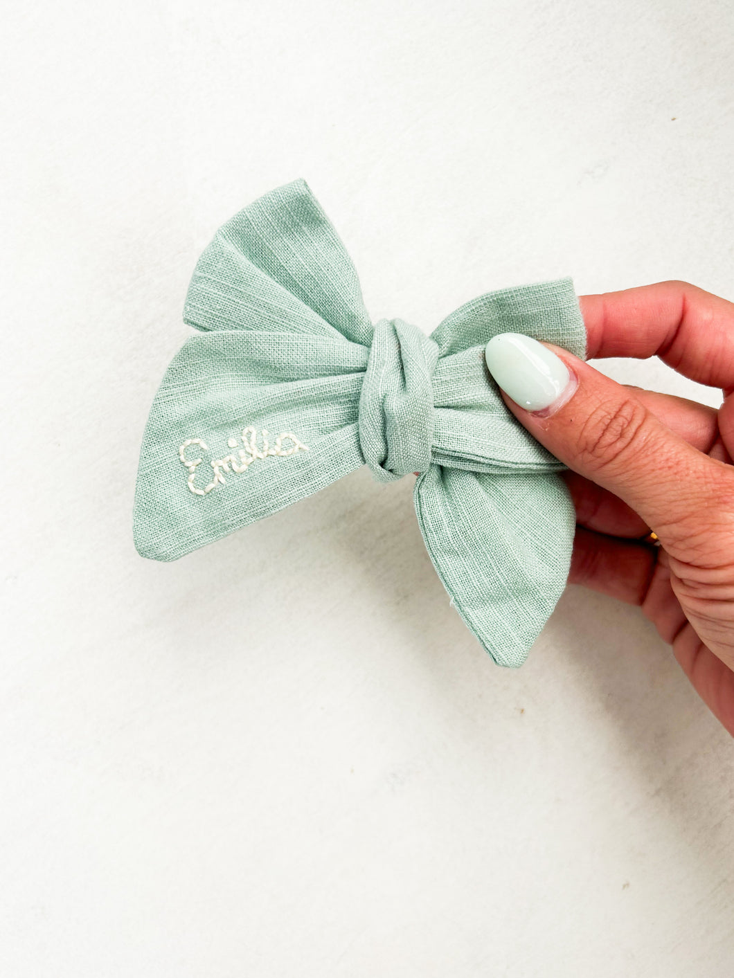 Hand embroidered sage bow